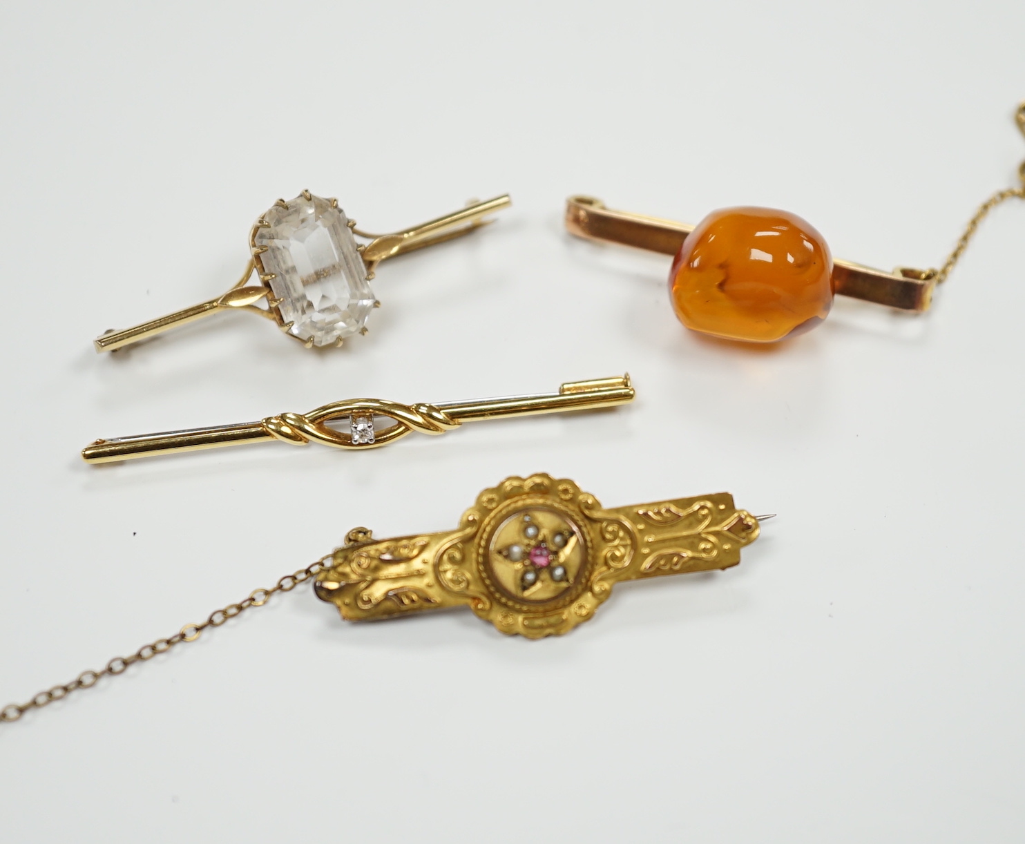 A 750 yellow metal and single stone diamond set bar brooch, 53mm, gross weight 2 grams and three other bar brooches including one 9ct gold and one yellow metal.